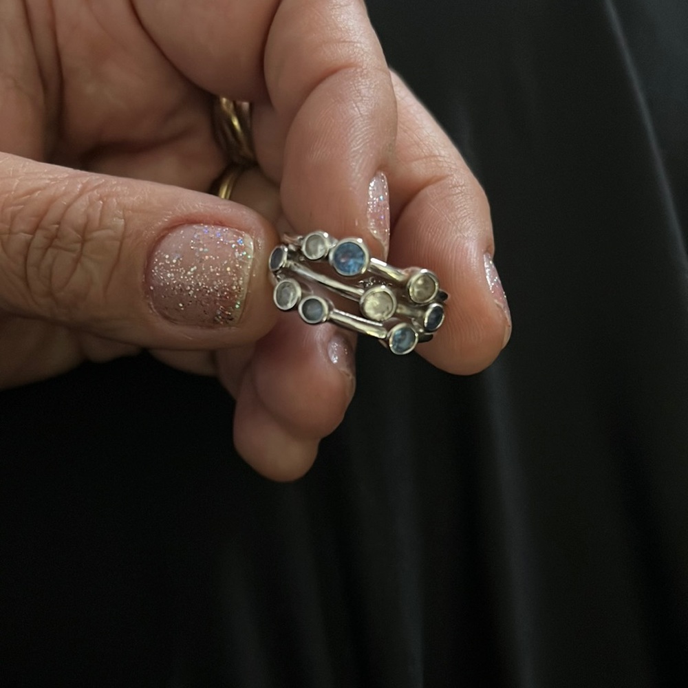 Silver ring with blue and white topaz